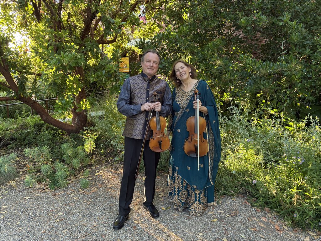 Bollywood California- violin duo, posing on balcony before performance in San Jose